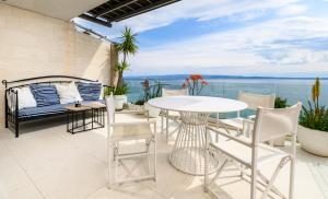 a patio with a white table and chairs at Gallery Luxury Suites & Rooms-Only Adults in Split