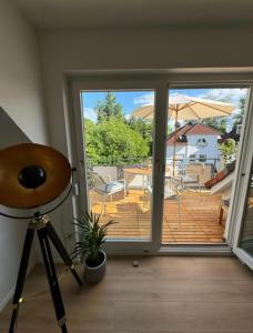 a room with a sliding glass door with a deck at SEEgold in Unteruhldingen