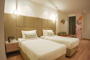 a hotel room with two beds and a chair at Best Western AH1 Amritsar in Amritsar