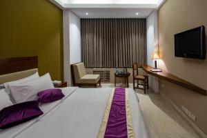 Postel nebo postele na pokoji v ubytování Hotel Ashrafee
