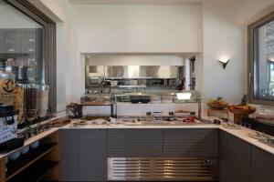 a large kitchen with a large island in the middle at Oniro Boutique Hotel in Toroni