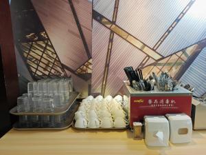 a room with a counter with glasses and bottles at City Comfort Hotel Kuala Lumpur City Center (Bukit Bintang) in Kuala Lumpur