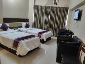 Postel nebo postele na pokoji v ubytování Hotel Ashrafee