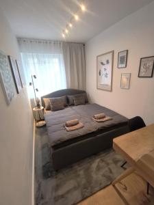 a bedroom with a bed with two pillows on it at SO Maison Petite in Augsburg