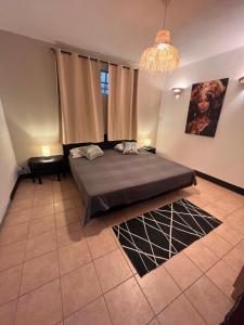 a bedroom with a bed and a chandelier at Appartement Lili in Grand-Baie +13 photos