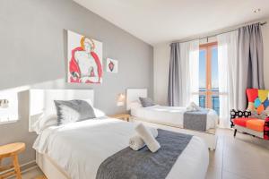 a bedroom with two beds and a chair at Mimar Altea Exclusive in Altea