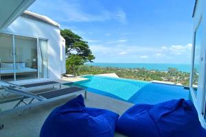 a view of a swimming pool from a villa at V2 Sunset Seaview BangPor in Ban Bang Po