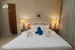 a bedroom with a bed with two stuffed animals on it at V2 Sunset Seaview BangPor in Ban Bang Po