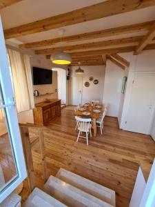 a living room with a wooden table and chairs at Waterfront House Carolina in Vis