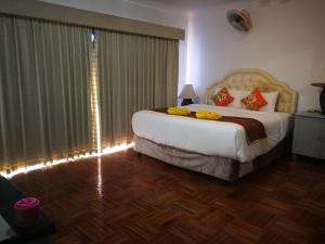 a bedroom with a large bed and a large window at Private Pattaya Resort in Nong Prue +61 photos