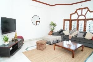 a living room with a couch and a coffee table at Nele in Mysore