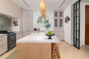 a kitchen with a island with a bowl of fruit on it at Luxury Villa Marca heated pool 36m2 in Nin