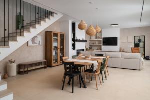 a dining room and living room with a table and chairs at Luxury Villa Marca heated pool 36m2 in Nin