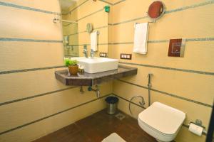 a bathroom with a sink and a toilet at Plutus Luxury Boutique Stays in Mussoorie +70 photos