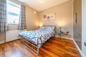 a bedroom with a bed and a window at Stylish 1BR Prime Location Near Station and Shops in South Norwood
