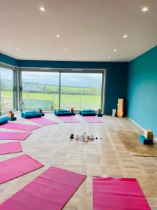 a large room with pink mats on the floor at Dorset Stay, Coast & Countryside in Puncknowle