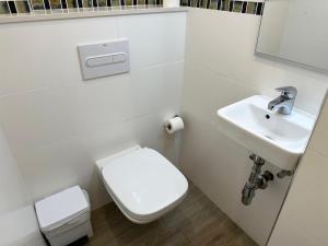 a white bathroom with a toilet and a sink at Paraiso 2 dormitorios en primera linea de mar - 333 in Pals +7 photos