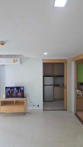 a living room with a flat screen tv on a table at The Feeltrue phuket ck in Ban Klang +12 photos