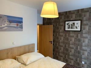 a bedroom with a bed and a lamp at Premium Resort Skalka in Železná Ruda +17 photos