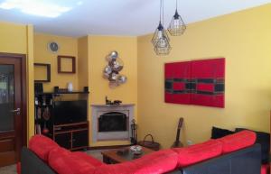 a living room with a red couch and a fireplace at Praia Espinho in Espinho