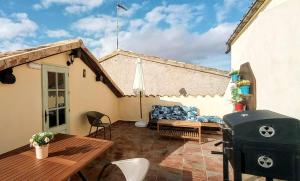 a patio with a couch and a table and a grill at Casa Rural Villa Huerta in Santa María de Huerta