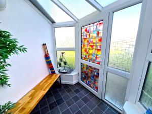 a room with a bench and a stained glass window at Idyllic location, Amazing view, Spacious in Marazion +72 photos