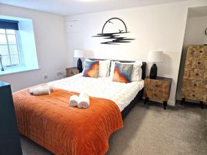 a bedroom with a bed with towels on it at Idyllic location, Amazing view, Spacious in Marazion