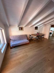 a living room with a bed and a table at Nave San Rocco, Trentino in Nave San Rocco