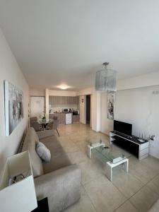 a living room with a couch and a glass table at Marianna Hotel Apartments in Limassol