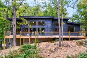 a house in the woods with a large deck at Bearodise By Beyond Expectations W Hot Tub in Glade