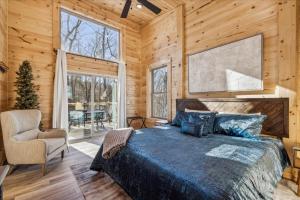 a bedroom with a bed and a large window at Bearodise By Beyond Expectations W Hot Tub in Glade