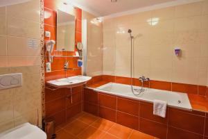 łazienka z wanną, toaletą i umywalką w obiekcie Hotel Joseph 1699 w mieście Třebíč +37 zdjęć
