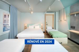 Ένα ή περισσότερα κρεβάτια σε δωμάτιο στο Ibis Budget Lyon Caluire Cité Internationale
