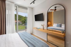 a bedroom with a bed and a large mirror at Villa ZaLú with Heated Pool in Srinjine +84 photos