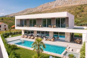 an aerial view of a house with a swimming pool at Villa ZaLú with Heated Pool in Srinjine