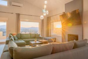 a living room with a couch and a fireplace at Villa Helyra in Heraklio