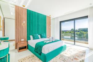 a bedroom with a green bed with a teddy bear on it at Villa Elysée - Piscine et jardin Privée Sans vis-à-vis Wifi HD in Sraghna +57 photos