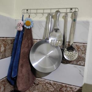 a bunch of utensils on a kitchen counter at Deivith Homestay Suite in Jowai