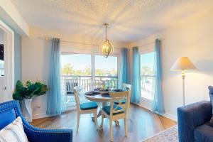 a dining room with a table and chairs and a window at Gulf Strand Resort 308 in St. Pete Beach