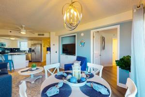 a living room and dining room with a table and chairs at Gulf Strand Resort 308 in St. Pete Beach +32 photos
