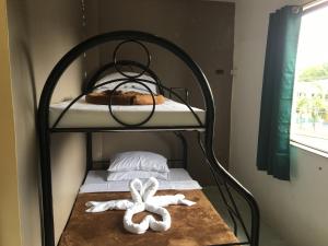 a metal bunk bed with two towels on it at Regina Hotel in Balasan