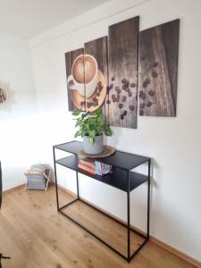 a black table with a plant on it in a room at FeWo Lichtblick in Mengen +56 photos