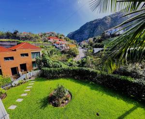 a view of a garden with a mountain in the background at Bela Vista House in Ponta Delgada