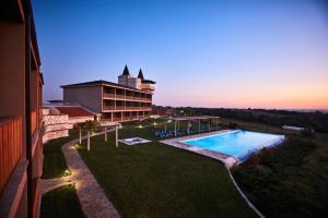 a resort with a swimming pool and a building at Bakucha Vineyard Hotel ve Spa in Lüleburgaz