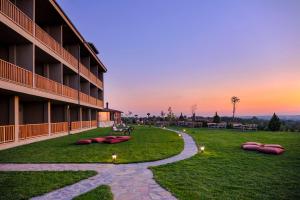 a building with red bean bags on the grass at Bakucha Vineyard Hotel ve Spa in Lüleburgaz