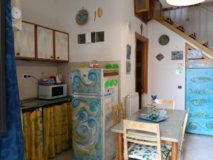a kitchen with an old refrigerator and a table at Little art house in Gaeta