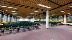 an empty room with green chairs in a building at Yarnfield Park Training And Conference Centre in Stone