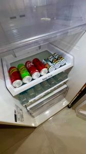 an open refrigerator filled with drinks and soda cans at Tiny Boutique House Koh Kood in Ban Lak Uan