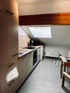 a kitchen with a sink and a stove top oven at Ferienwohnung Thullner inkl. Chiemgaukarte in Ruhpolding +13 photos