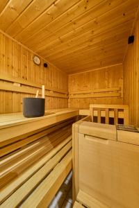 a wooden sauna with a clock on the wall at Haus Miller in Sankt Veit im Pongau